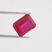 Ruby lab gemstone holded with tweezer with plain white background.