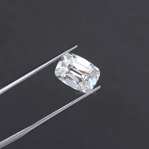 charming old mine cushion cut diamond holded with tweezer