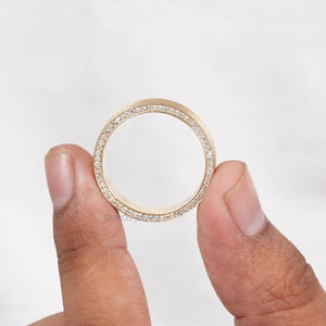 Mens Brushed Gold Ring hold in between two fingers.