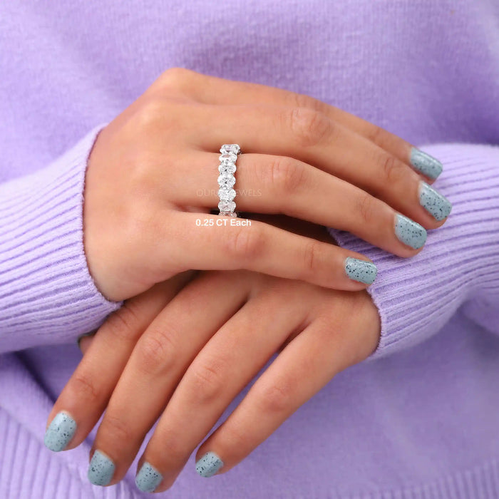 A Women wearing Oval Cut Lab Grown Diamond Eternity Band of 0.25 carat in ring finger.