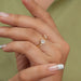 A Women wearing Pear and Round Toi Et Moi Engagement Ring