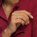 A women is wearing Baguette And Round Diamond Eternity Wedding Band in ring finger.