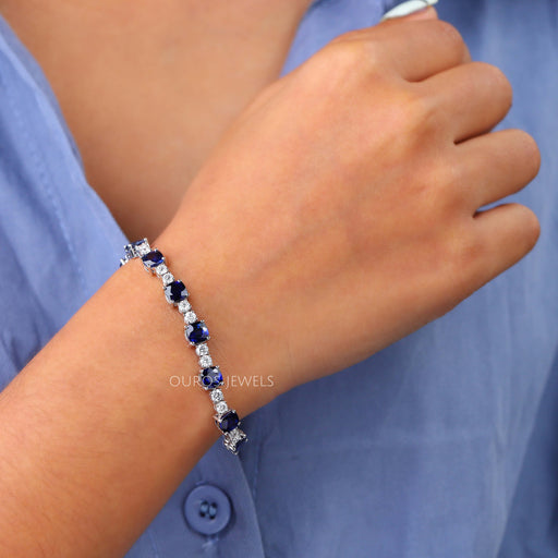 [A Women wearing Blue Sapphire Tennis Bracelet]-[Ouros Jewels]