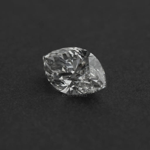 2.50 Carat Marquise Cut Loose Diamond resting on a dark surface, highlighting its intricate facets and clarity.