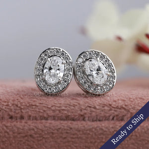 Oval cut lab grown diamond stud earrings with a lovely halo of round diamonds 