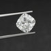 2.5 Carat Cushion Cut Loose Diamond held by tweezers against a dark background, showcasing its brilliance and clarity.