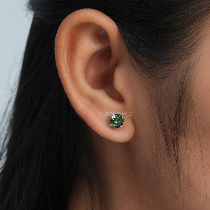 green diamond earring weared by women 