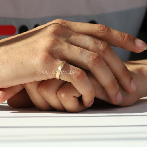 matte finsihed wedding band on finger