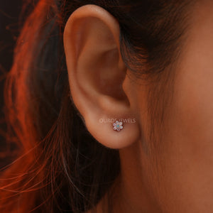 women wearing pink and blue round diamond stud earring